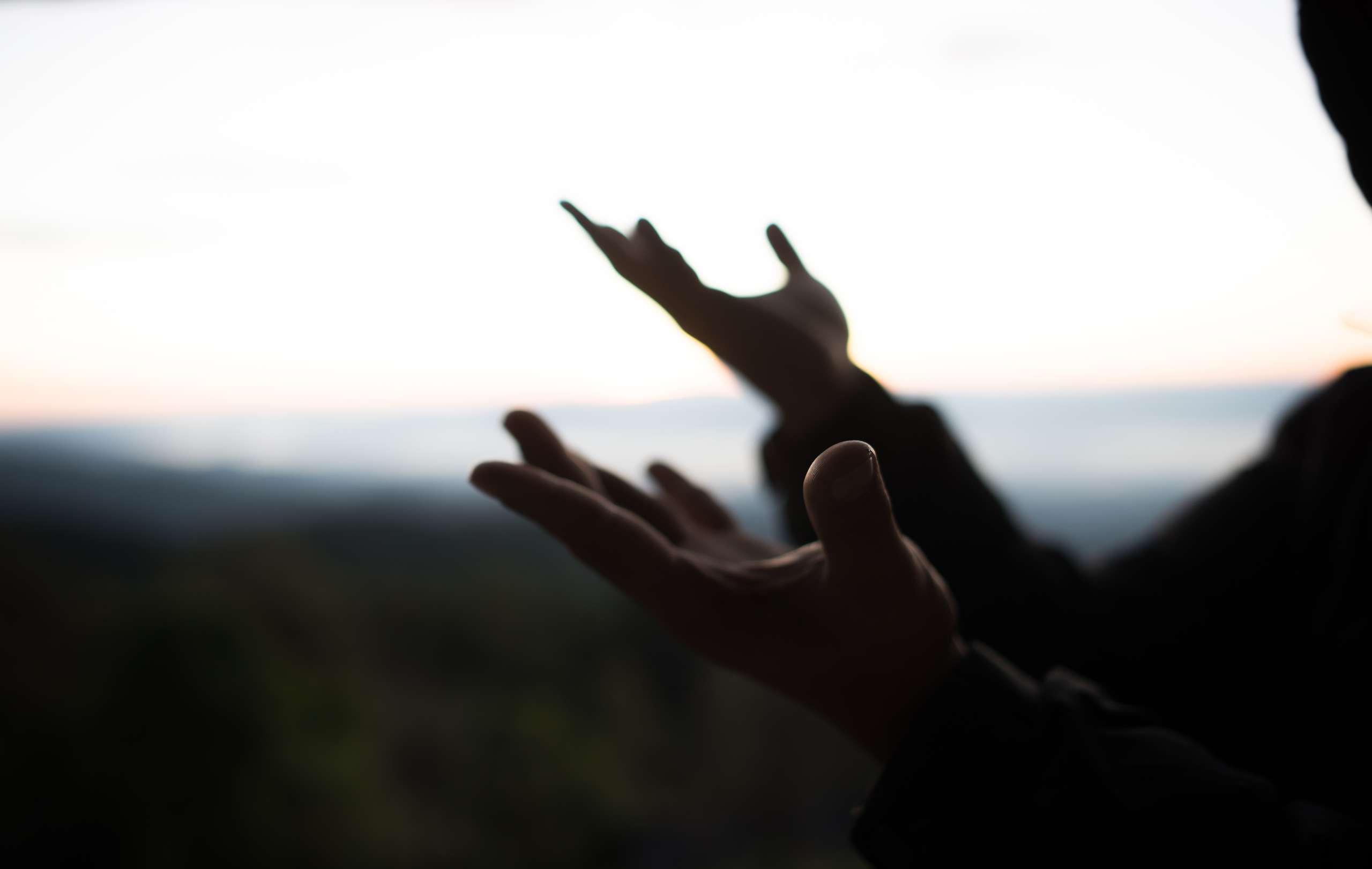 Silhouette of Hand hold cross of God